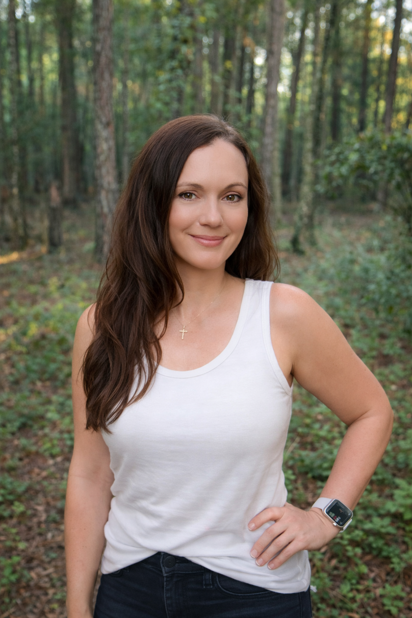 Dr. Lyndsay Carlson, PharmD, BCACP, standing in a forest